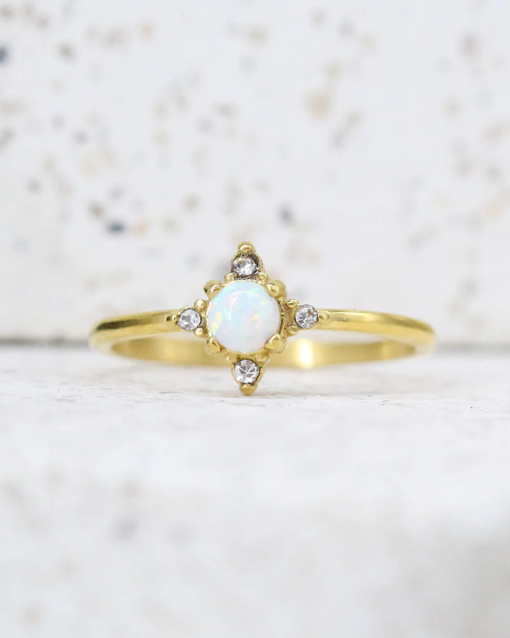 Gold plated opal engagement ring with diamond accents, celestial design
Delicate gold plated opal ring with starburst setting, anniversary gift