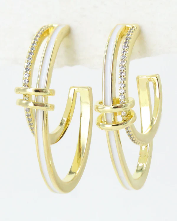 Gold hoop stud earrings with white enamel and zirconia embedded stones on a white background