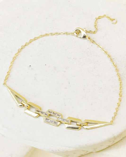 Gold chain bracelet with angular geometric links and adjustable clasp.