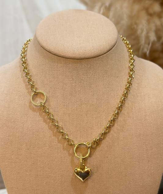 Gold chain necklace with a heart pendant on a beige mannequin bust.