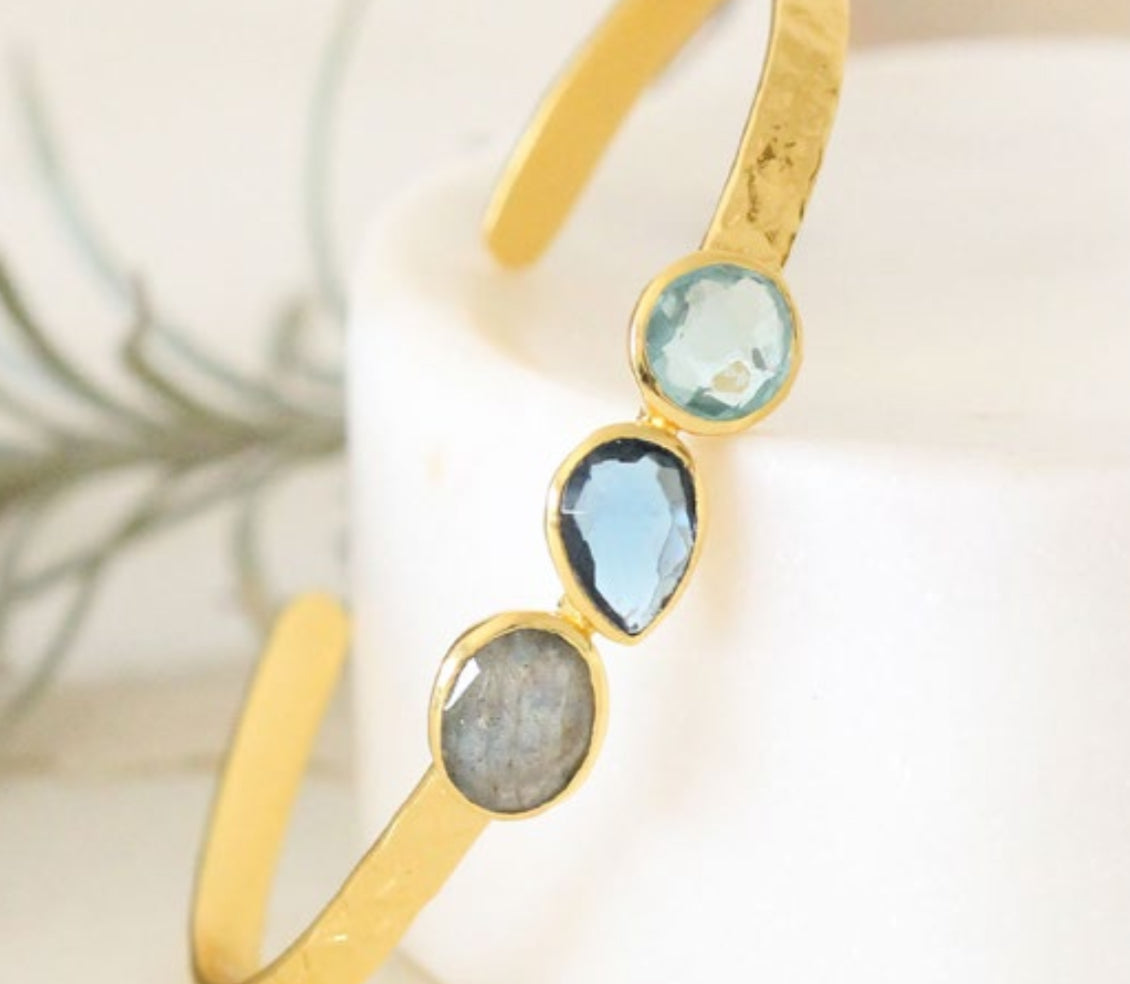 Gold gemstone cuff bracelet featuring aquamarine, blue topaz, and labradorite stones in a minimalist handmade design boho cuff textured cuff bracelet with gemstones