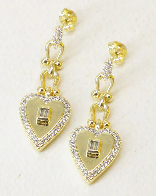 Gold heart-shaped chain-drop down stud earrings with clear zirconia stones on a light background