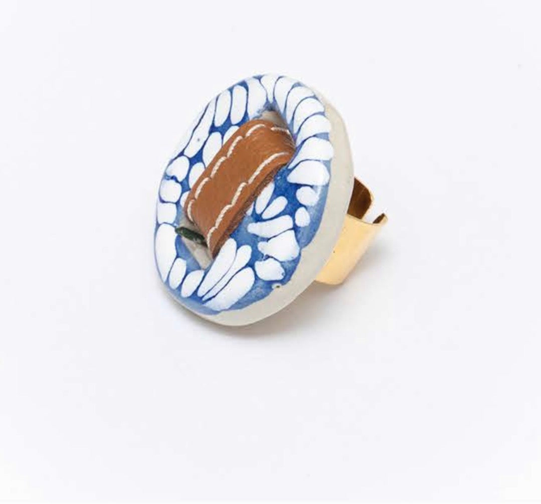 Decorative knob belt clay handcrafted unique artisan pattern ring a gift for women with blue and white pattern on a white background