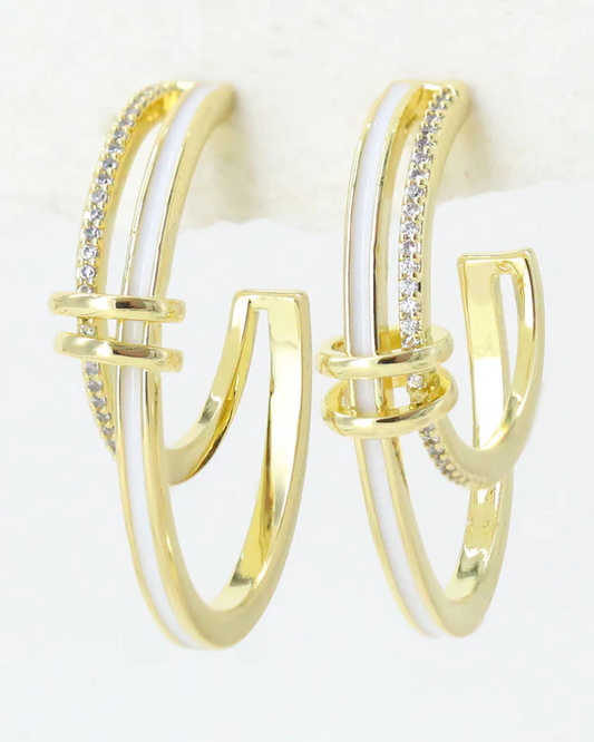 Gold hoop stud earrings with white enamel and zirconia embedded stones on a white background